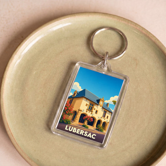 Porte-clés souvenir de la ville de Lubersac avec une illustration stylisée.