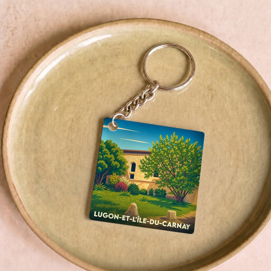 Porte-clés souvenir de la ville de Lugon-et-l'Île-du-Carnay avec une illustration paysagère stylisée.
