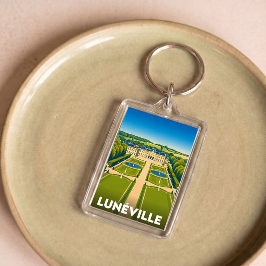 Porte-clés souvenir de la ville de Lunéville avec une illustration stylisée.