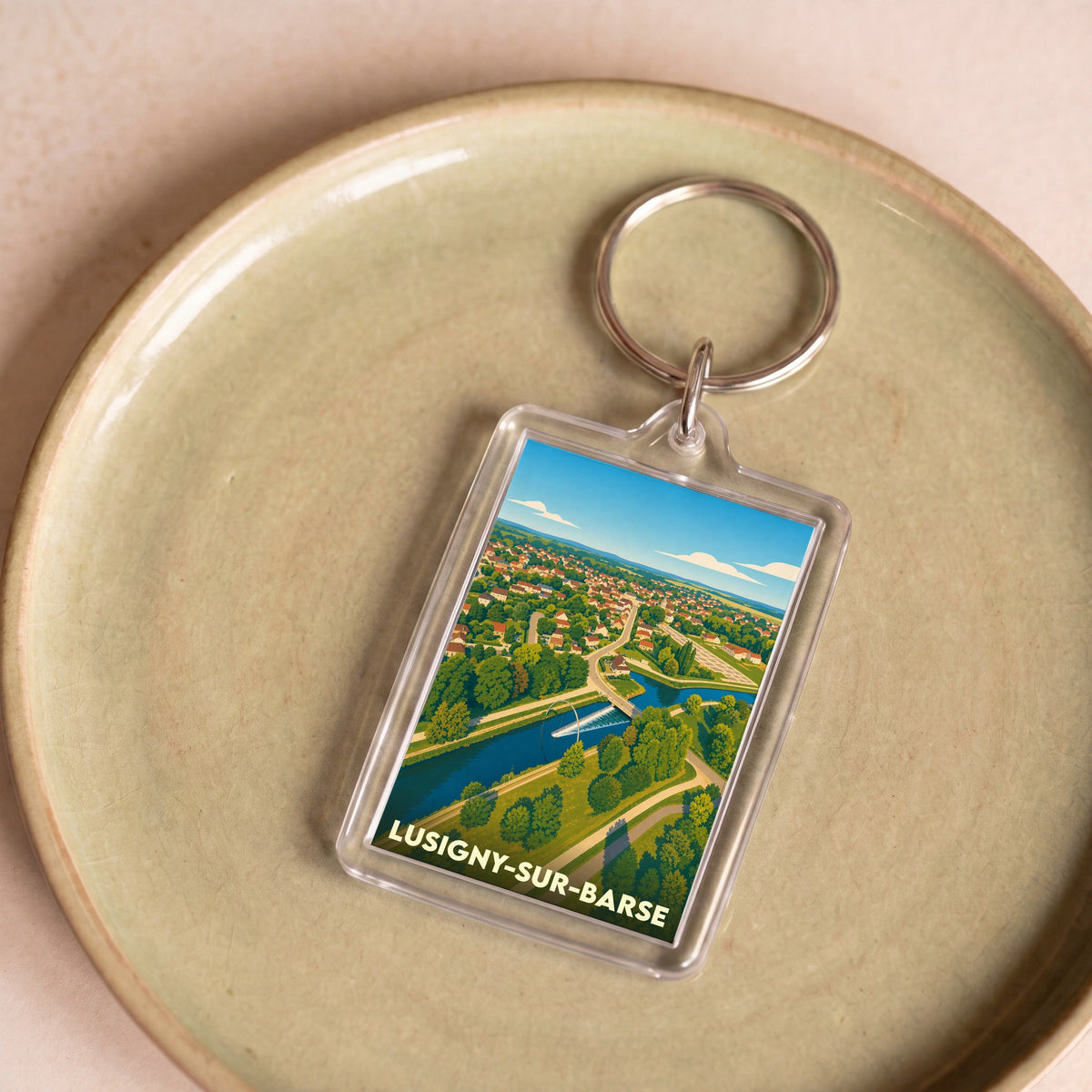 Porte-clés souvenir de la ville de Lusigny-sur-Barse avec une illustration stylisée.