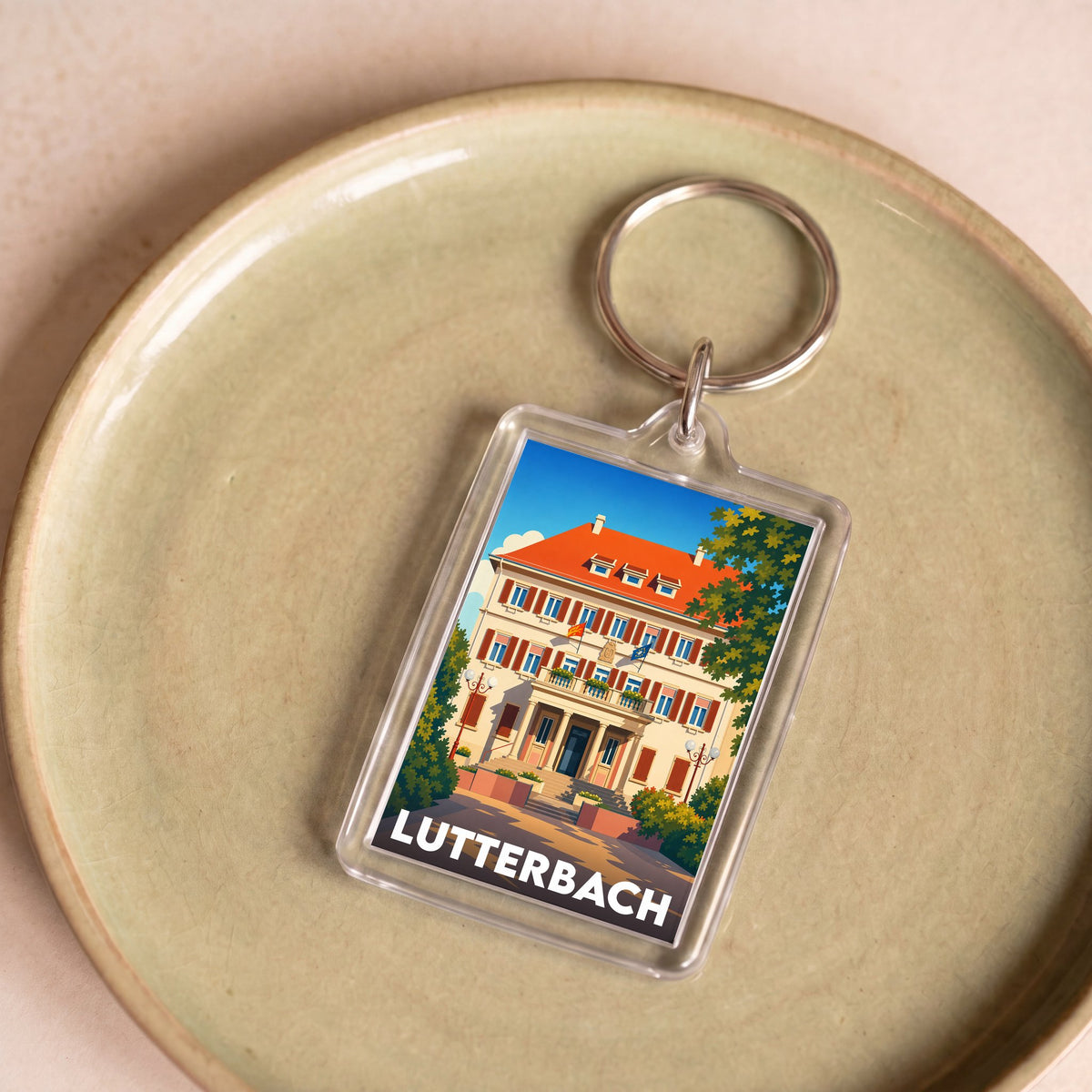 Porte-clés souvenir de la ville de Lutterbach avec une illustration stylisée de son architecture.