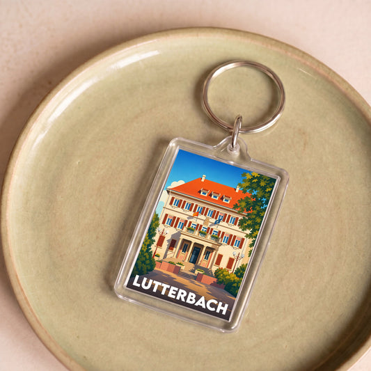 Porte-clés souvenir de la ville de Lutterbach avec une illustration stylisée de son architecture.