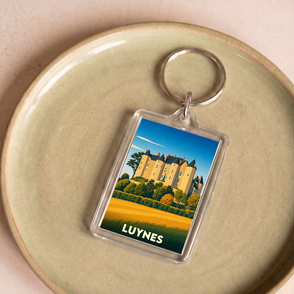 Porte-clés souvenir de la ville de Luynes avec une illustration stylisée de son château.