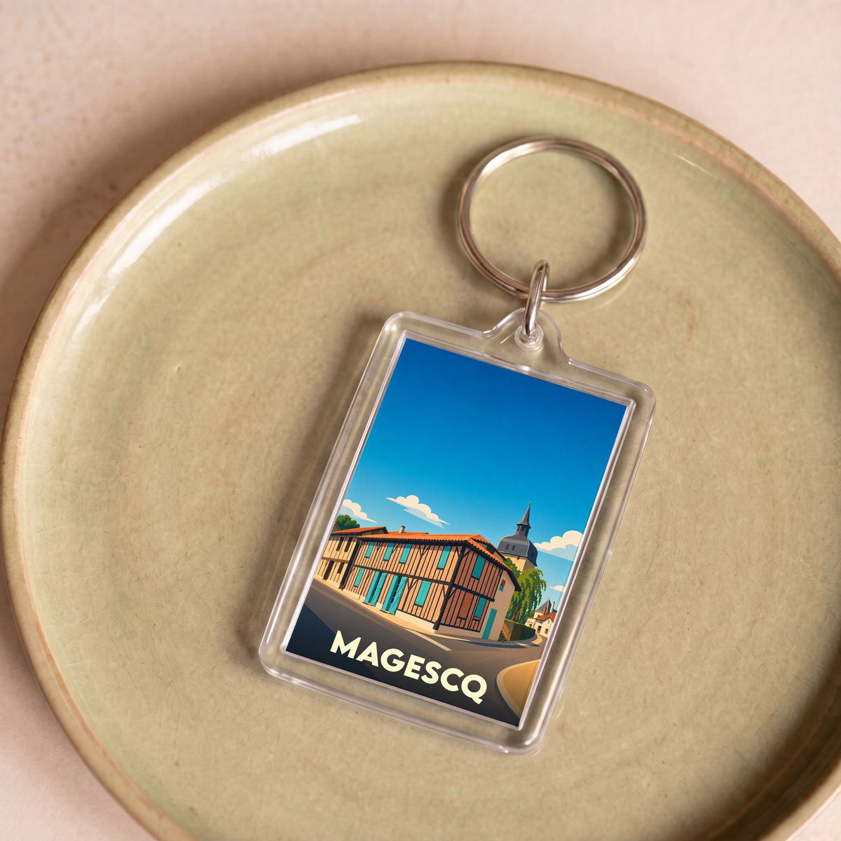 Porte-clés souvenir de la ville de Magescq avec une illustration stylisée.