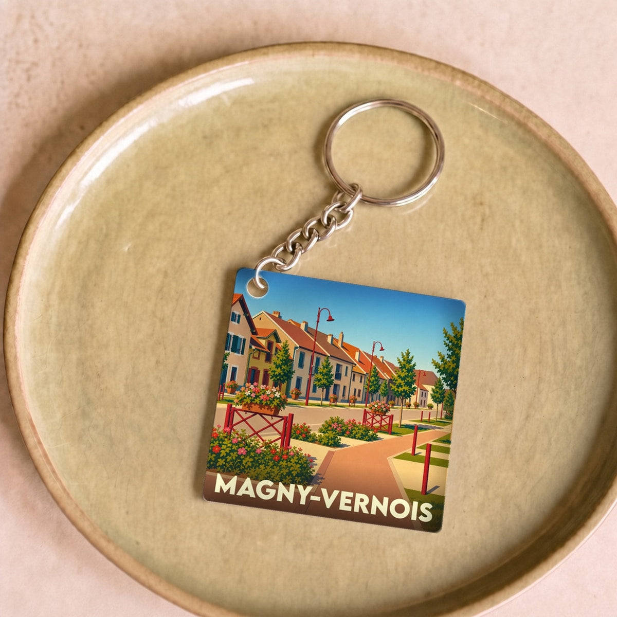 Porte-clés souvenir de la ville de Magny-Vernois avec une illustration stylisée.