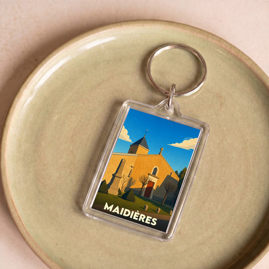 Porte-clés souvenir de la ville de Maidières avec une illustration stylisée de son église.