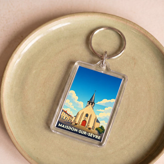Porte-clés souvenir de la ville de Maisdon-sur-Sèvre avec une illustration stylisée de son église.