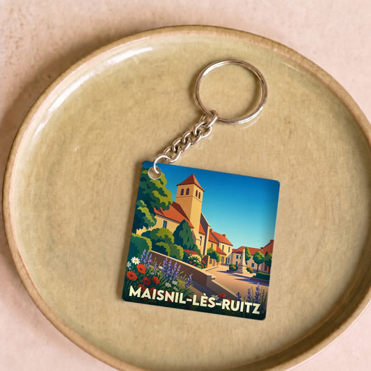 Porte-clés souvenir de la ville de Maisnil-lès-Ruitz avec une illustration colorée et stylisée.