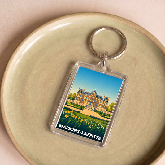 Porte-clés souvenir de la ville de Maisons-Laffitte avec une illustration stylisée.