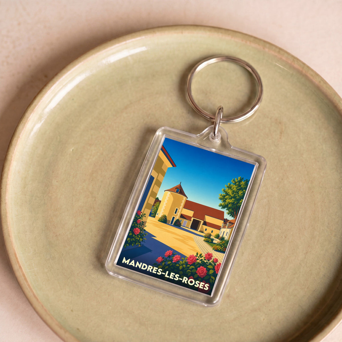 Porte-clés souvenir de la ville de Mandres-les-Roses avec une illustration stylisée.