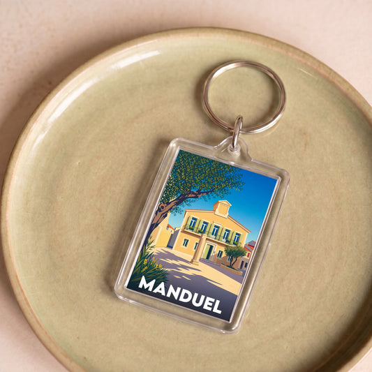 Porte-clés souvenir de la ville de Manduel avec une illustration stylisée.