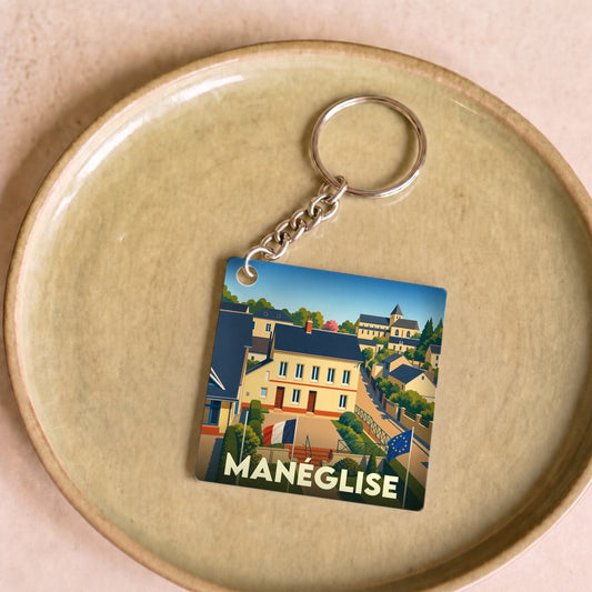 Porte-clés souvenir de la ville de Manéglise avec une illustration stylisée.