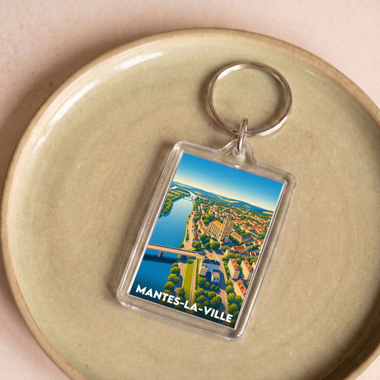 Porte-clés souvenir de la ville de Mantes-la-Ville avec une illustration stylisée.