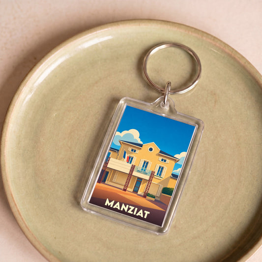 Porte-clés souvenir de la ville de Manziat avec une illustration stylisée de sa mairie.