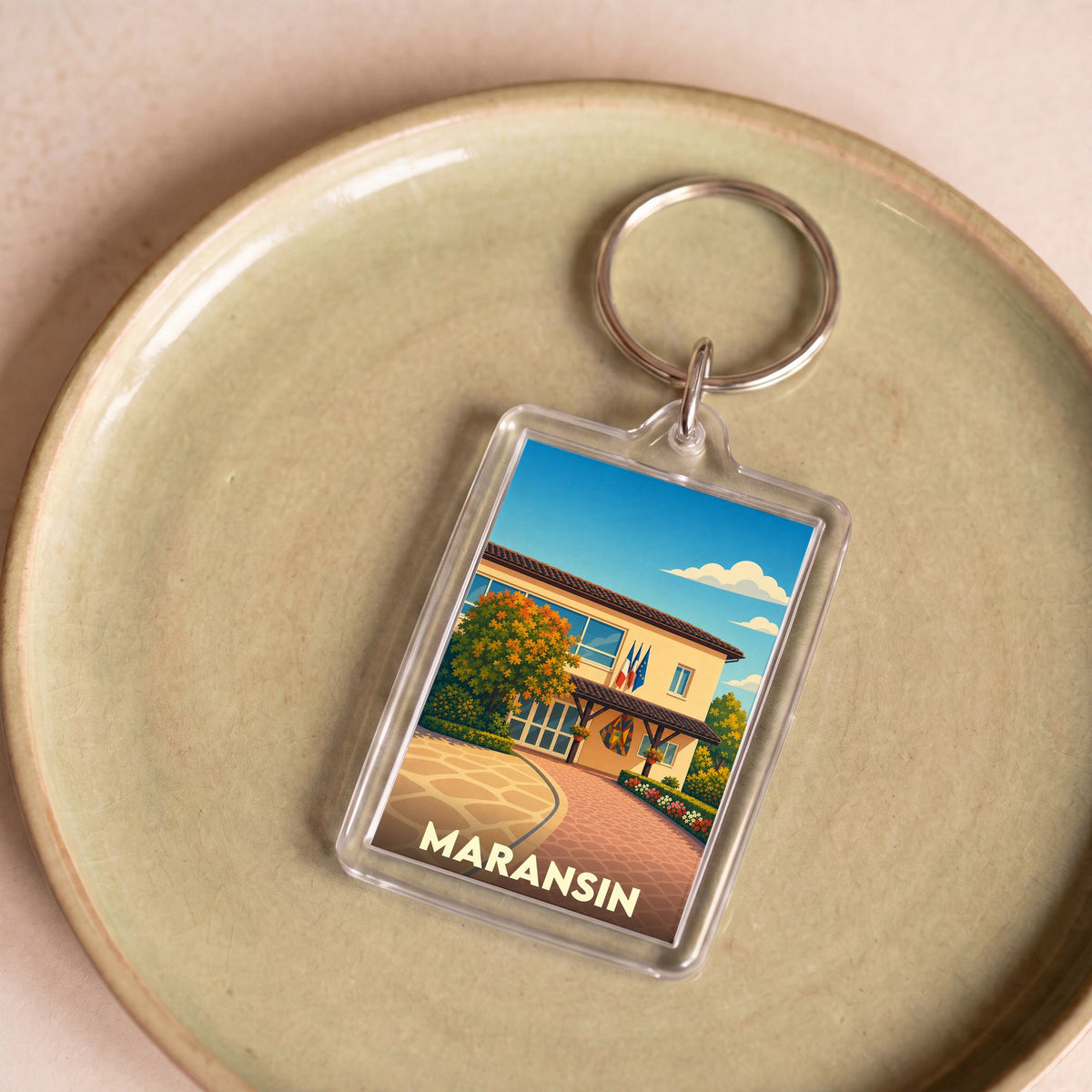 Porte-clés souvenir de la ville de Maransin avec une illustration stylisée.