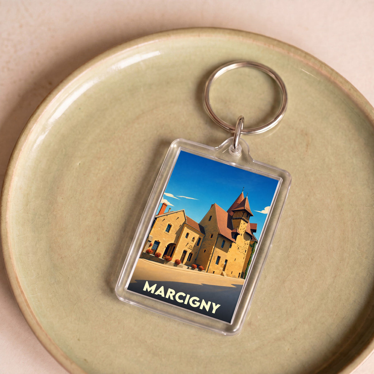 Porte-clés souvenir de la ville de Marcigny avec une illustration stylisée de son architecture historique.