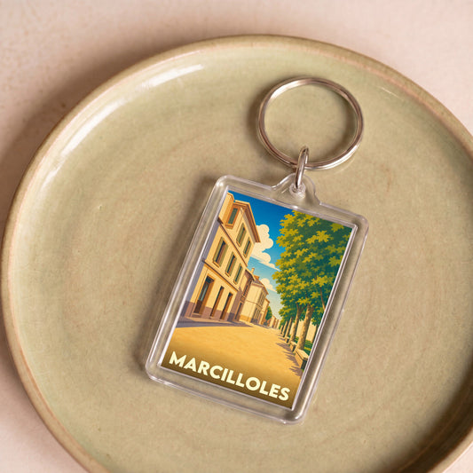 Porte-clés souvenir de la ville de Marcilloles avec une illustration stylisée.