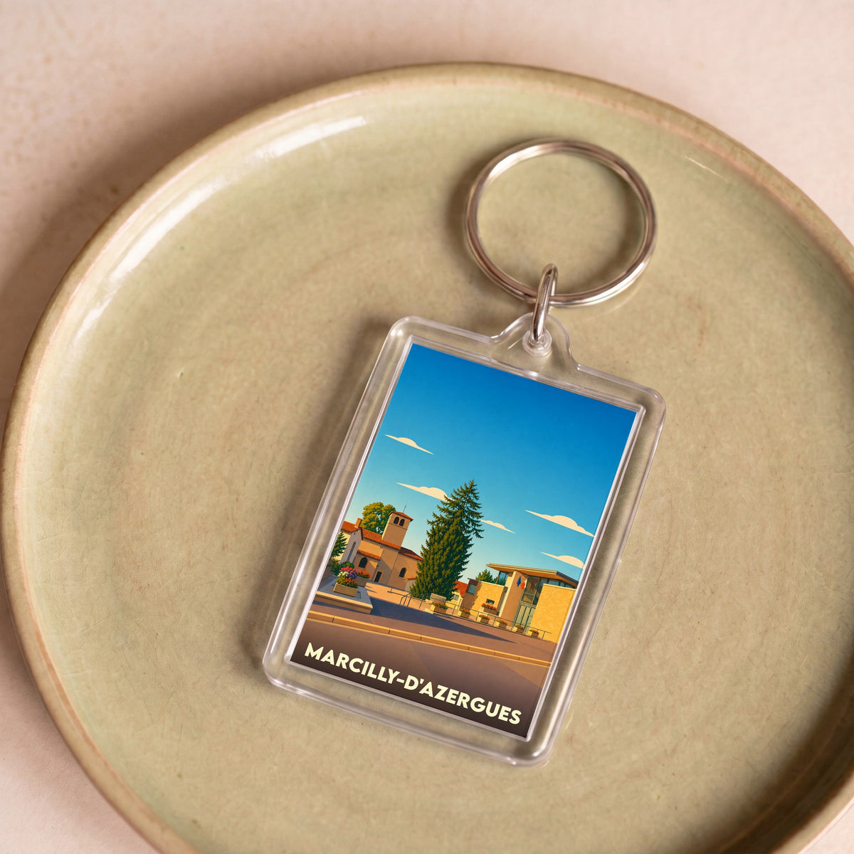 Porte-clés souvenir de la ville de Marcilly-d'Azergues avec une illustration stylisée.