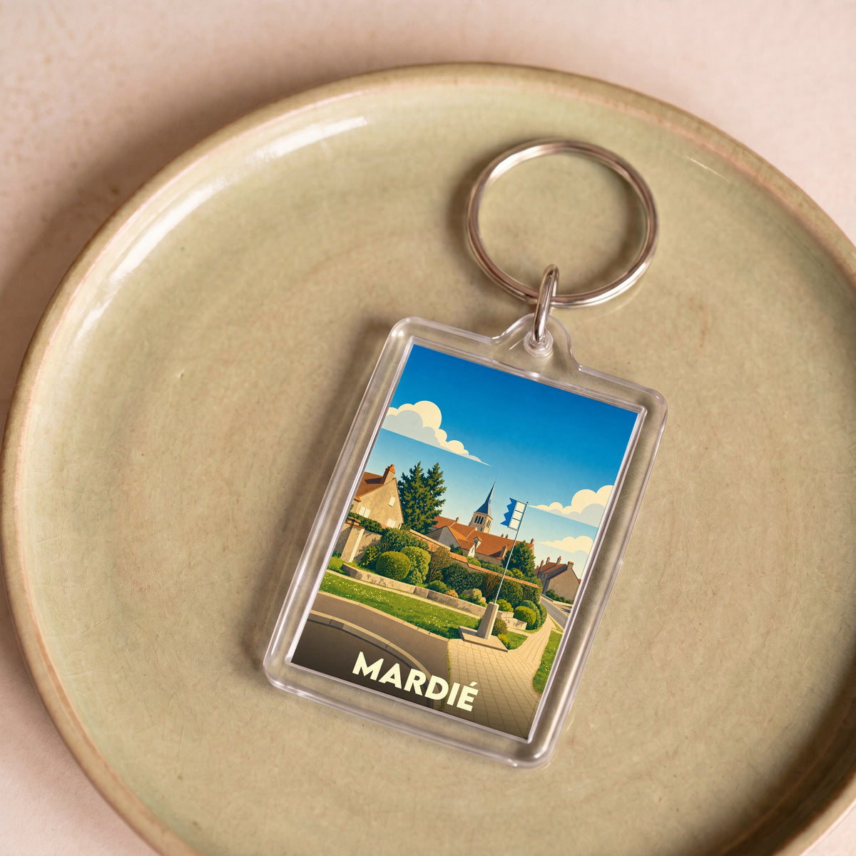 Porte-clés souvenir de la ville de Mardié avec une illustration stylisée.