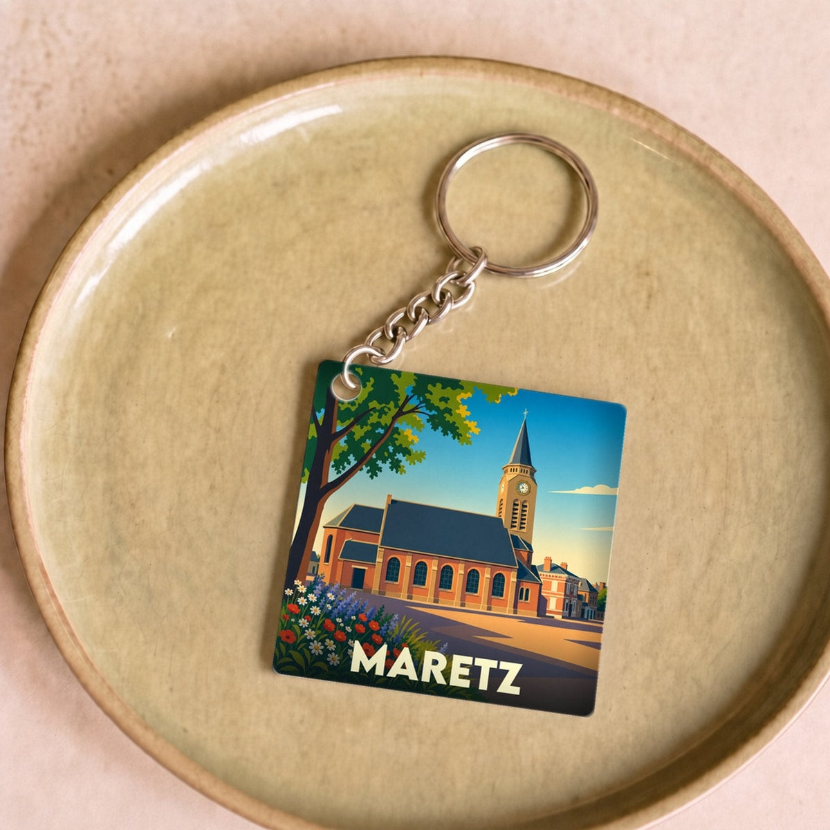 Porte-clés souvenir de la ville de Maretz avec une illustration stylisée.
