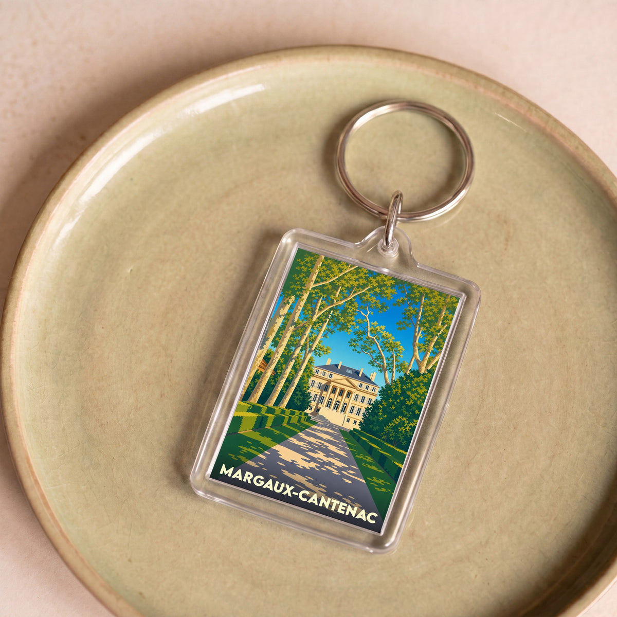 Porte-clés souvenir de la ville de Margaux-Cantenac avec une illustration stylisée d'un château.