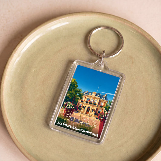 Porte-clés souvenir de la ville de Margny-lès-Compiègne avec une illustration colorée et stylisée.