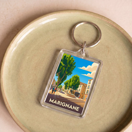 Porte-clés souvenir de la ville de Marignane avec une illustration stylisée.