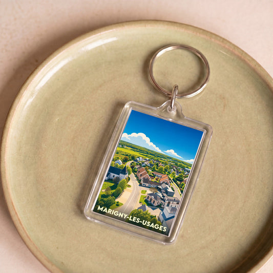 Porte-clés souvenir de la ville de Marigny-les-Usages avec une illustration aérienne stylisée.