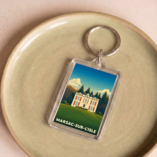 Porte-clés souvenir de la ville de Marsac-sur-l'Isle avec une illustration stylisée d'un château.