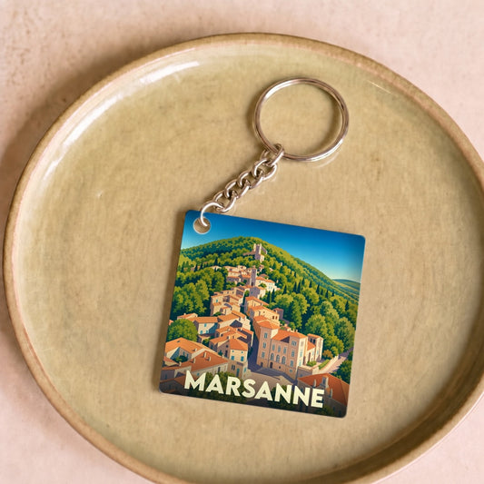 Porte-clés souvenir de la ville de Marsanne avec une illustration stylisée d'un village perché.