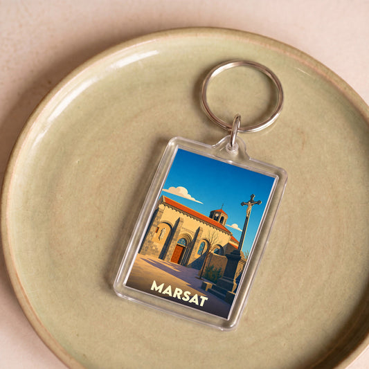 Porte-clés souvenir de la ville de Marsat avec une illustration stylisée de son église.