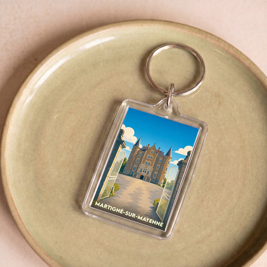Porte-clés souvenir de Martigné-sur-Mayenne avec une illustration stylisée du château local.