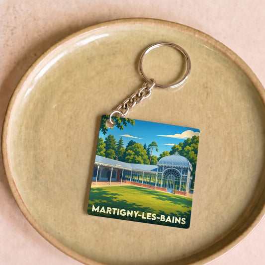 Porte-clés souvenir de la ville de Martigny-les-Bains avec une illustration stylisée d'un pavillon thermal.