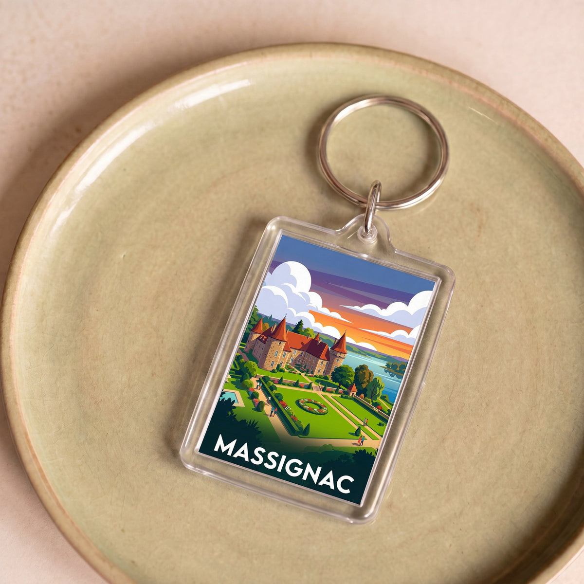 Porte-clés souvenir de la ville de Massignac avec une illustration stylisée.