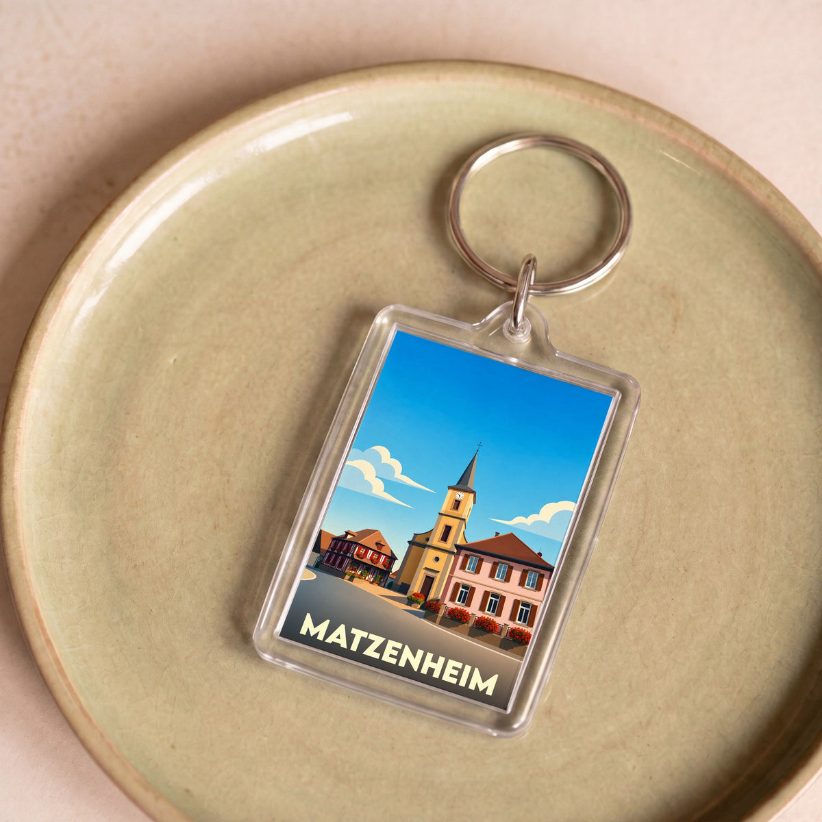 Porte-clés souvenir de la ville de Matzenheim avec une illustration stylisée.