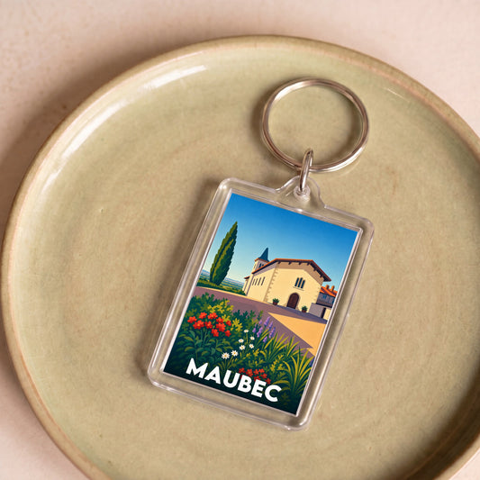 Porte-clés souvenir de la ville de Maubec avec une illustration stylisée et colorée.