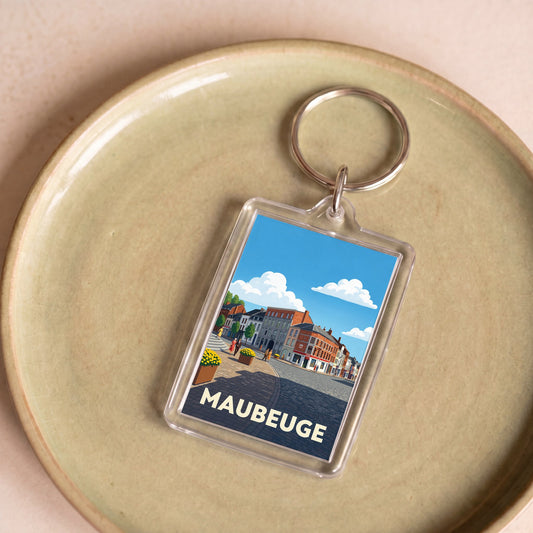 Porte-clés souvenir de la ville de Maubeuge avec une illustration stylisée.