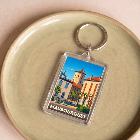 Porte-clés souvenir de la ville de Maubourguet avec une illustration stylisée.