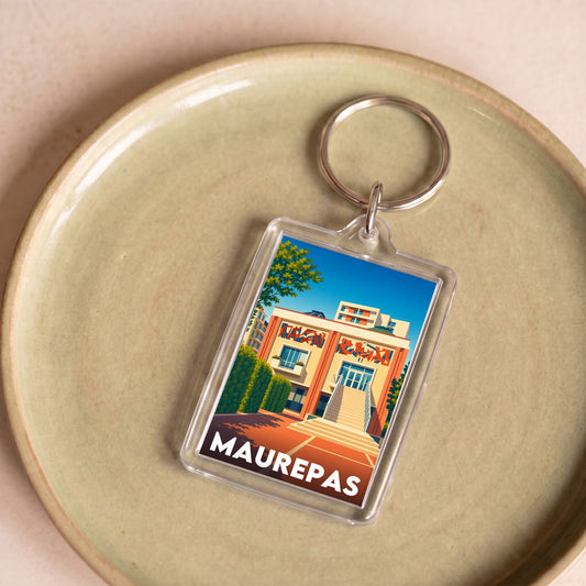 Porte-clés souvenir de la ville de Maurepas avec une illustration stylisée.