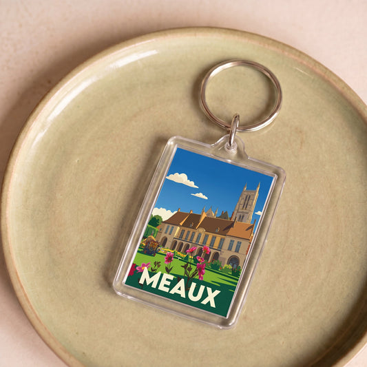 Porte-clés souvenir de la ville de Meaux avec une illustration stylisée d'un monument historique.