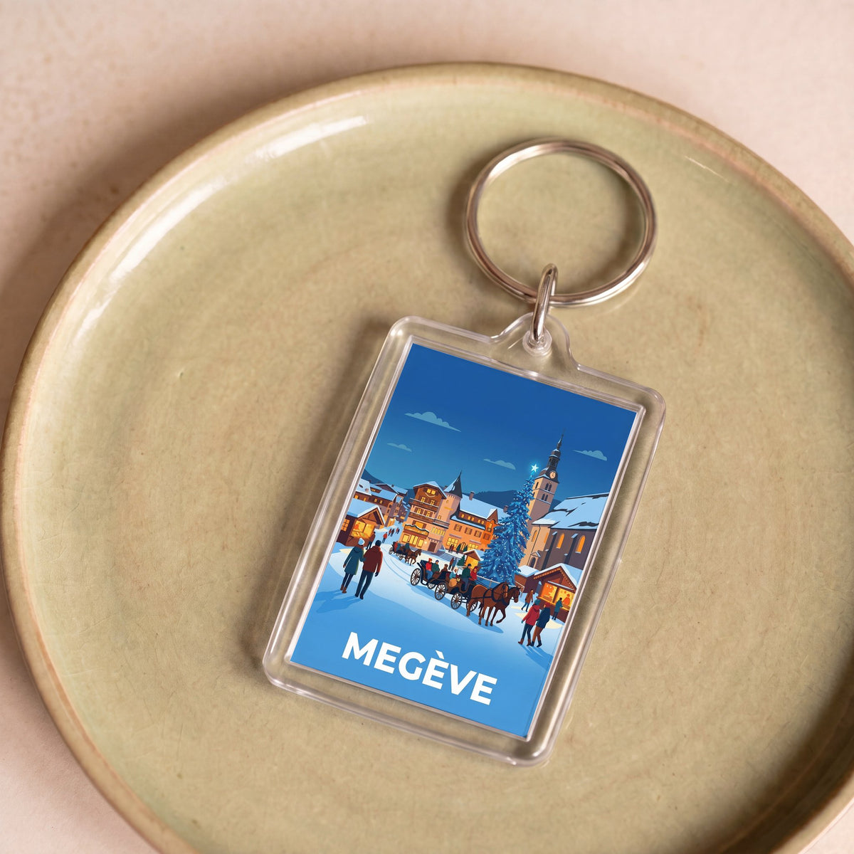 Porte-clés souvenir de la ville de Megève avec une illustration stylisée.