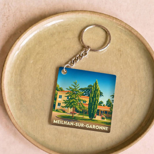 Porte-clés souvenir de Meilhan-sur-Garonne avec une illustration stylisée et colorée de la ville.