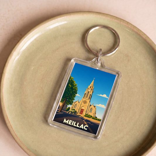 Porte-clés souvenir de la ville de Meillac avec une illustration stylisée de son église.
