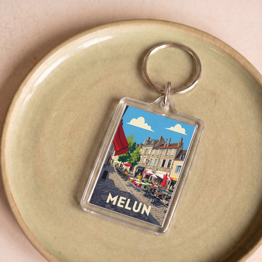 Porte-clés souvenir de la ville de Melun avec une illustration stylisée.