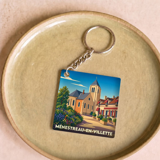 Porte-clés souvenir de la ville de Ménestreau-en-Villette avec une illustration stylisée.