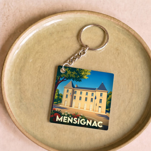 Porte-clés souvenir de la ville de Mensignac avec une illustration stylisée de son château.