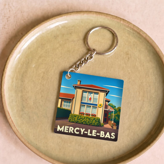 Porte-clés souvenir de la ville de Mercy-le-Bas avec une illustration stylisée.