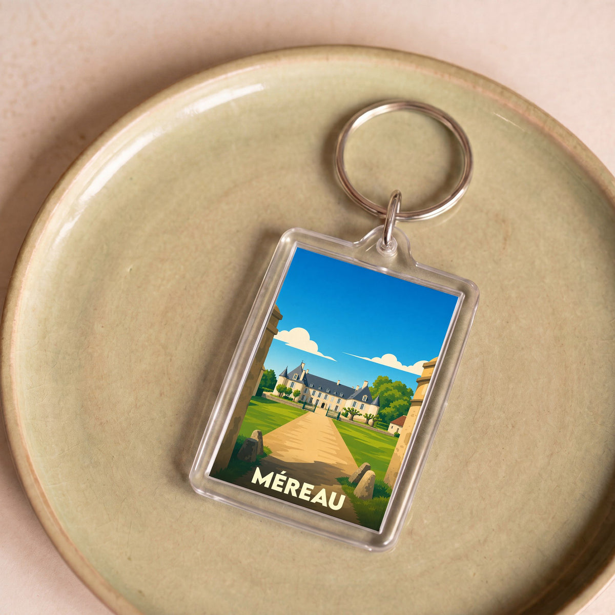 Porte-clés souvenir de la ville de Méreau avec une illustration stylisée d'un château.