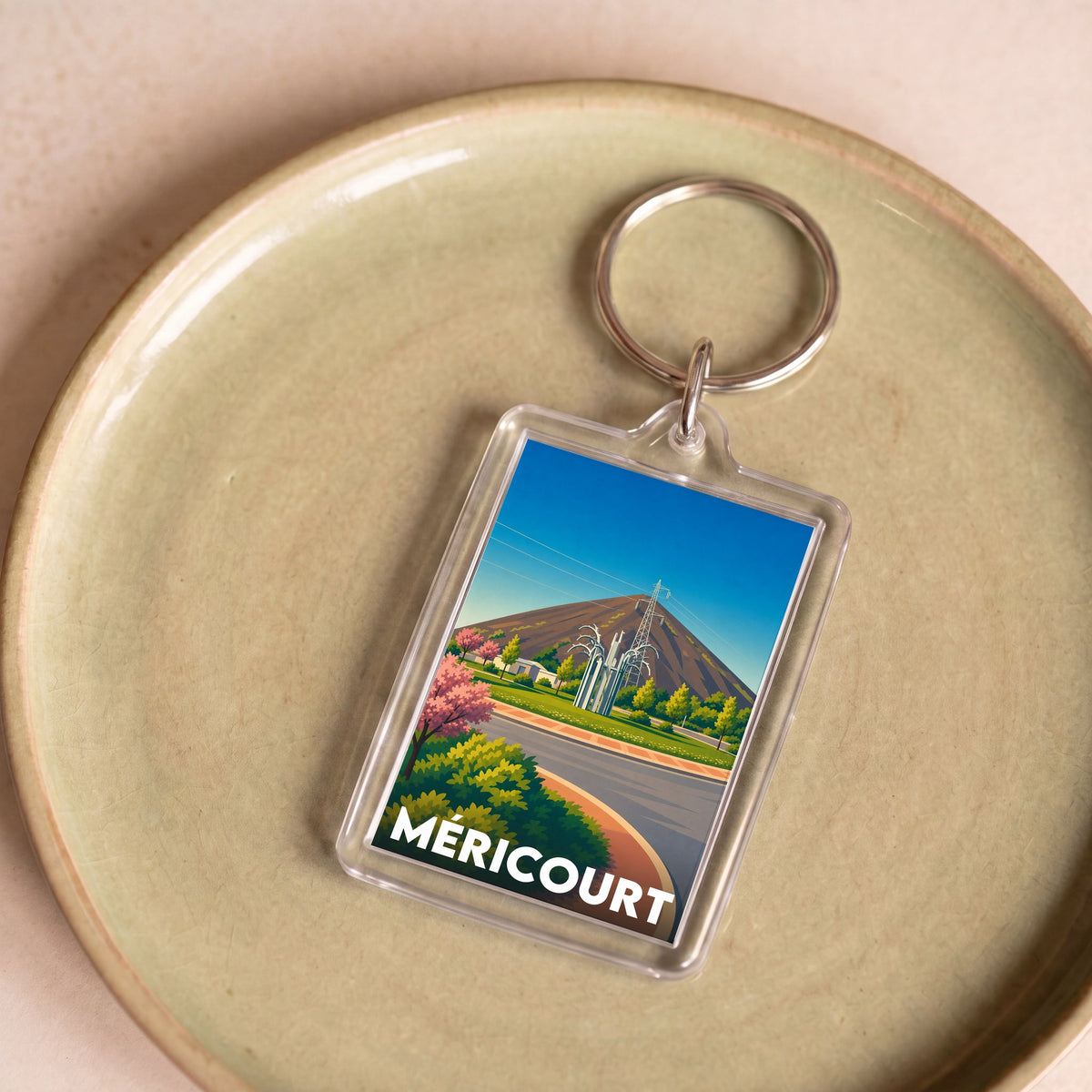 Porte-clés souvenir de la ville de Méricourt avec une illustration stylisée.