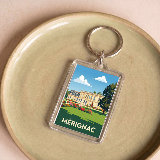 Porte-clés souvenir de la ville de Mérignac avec une illustration stylisée.